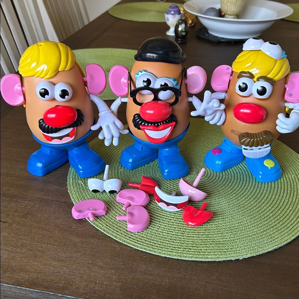 Electronic Mr potato head and a Mr potato head with some missing pieces.